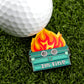The Dumpster Fire ball marker from Ballmarkers by Logie Joes features a smiling dumpster with flames and googly eyes labeled Im fine—a quirky, funny accessory for golfers and fans of unique golf ball markers.