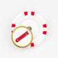 A Ballmarkers by Logie Joes Kansas City Chiefs set featuring a white poker chip ball marker with red accents and a round Chiefs pin with bold red letters outlined in yellow on top of the chip.