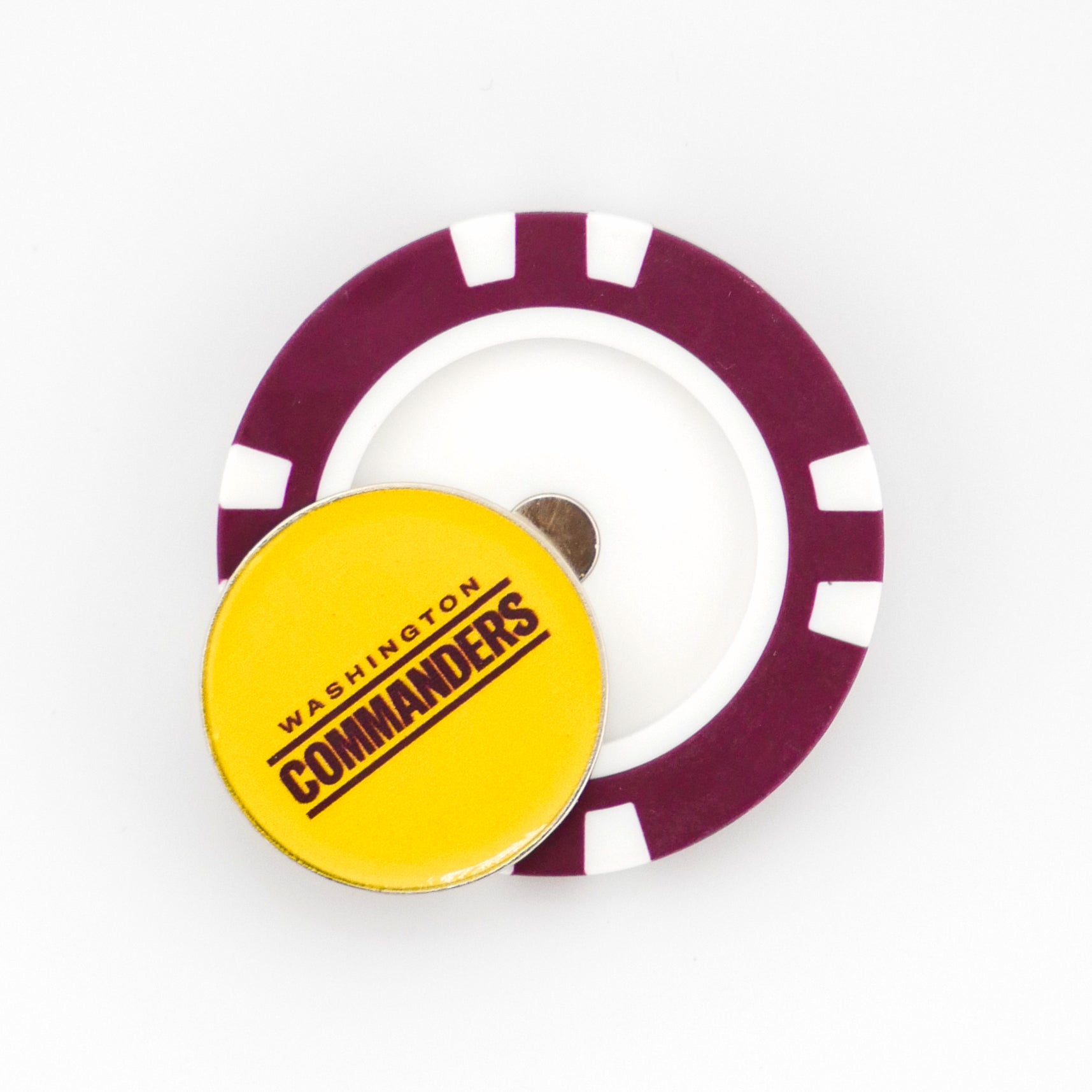 A yellow circular Washington Commanders ball marker by Ballmarkers from Logie Joes is placed on a purple and white poker chip-style marker, set against a plain white background.