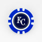 A blue and white poker chip ball marker by Ballmarkers from Logie Joe’s, featuring the Kansas City Royals logo—an ideal addition to any MLB fans golf set.